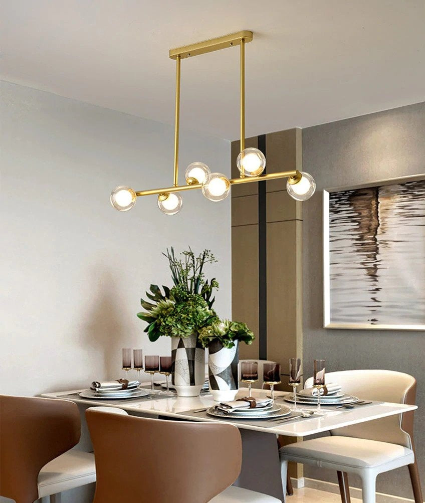 6 bulb clear glass globe horizontal modern chandelier with brass accents