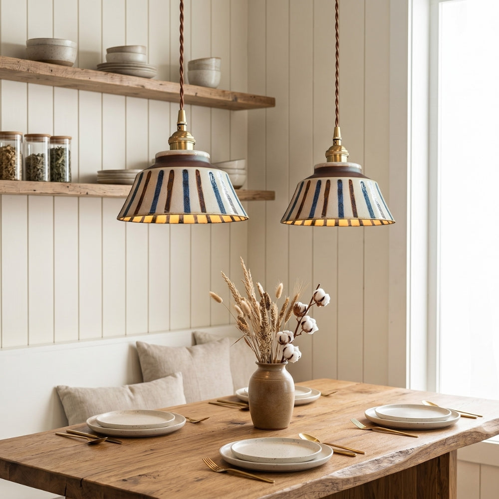 Dining room with wooden table, striped pendant lights, and shelves.