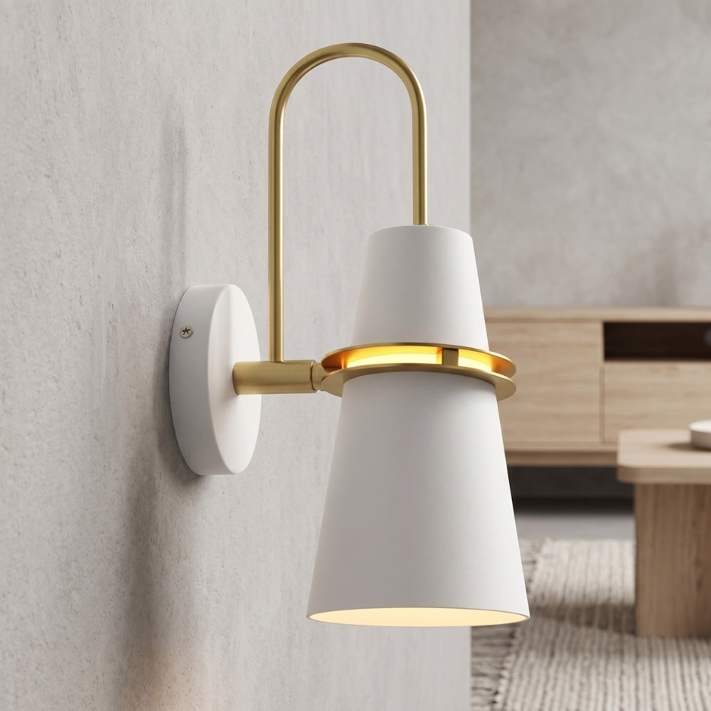 Modern wall sconce with white shade and gold accents on a neutral wall.