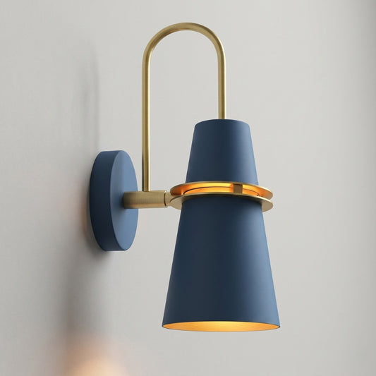 Wall-mounted lamp with blue shade and gold accents on a gray wall