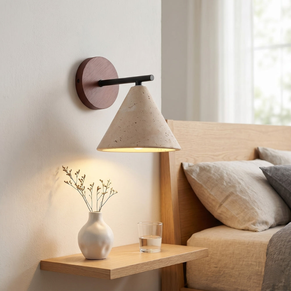 Modern wall lamp with concrete shade in a cozy living room setting.