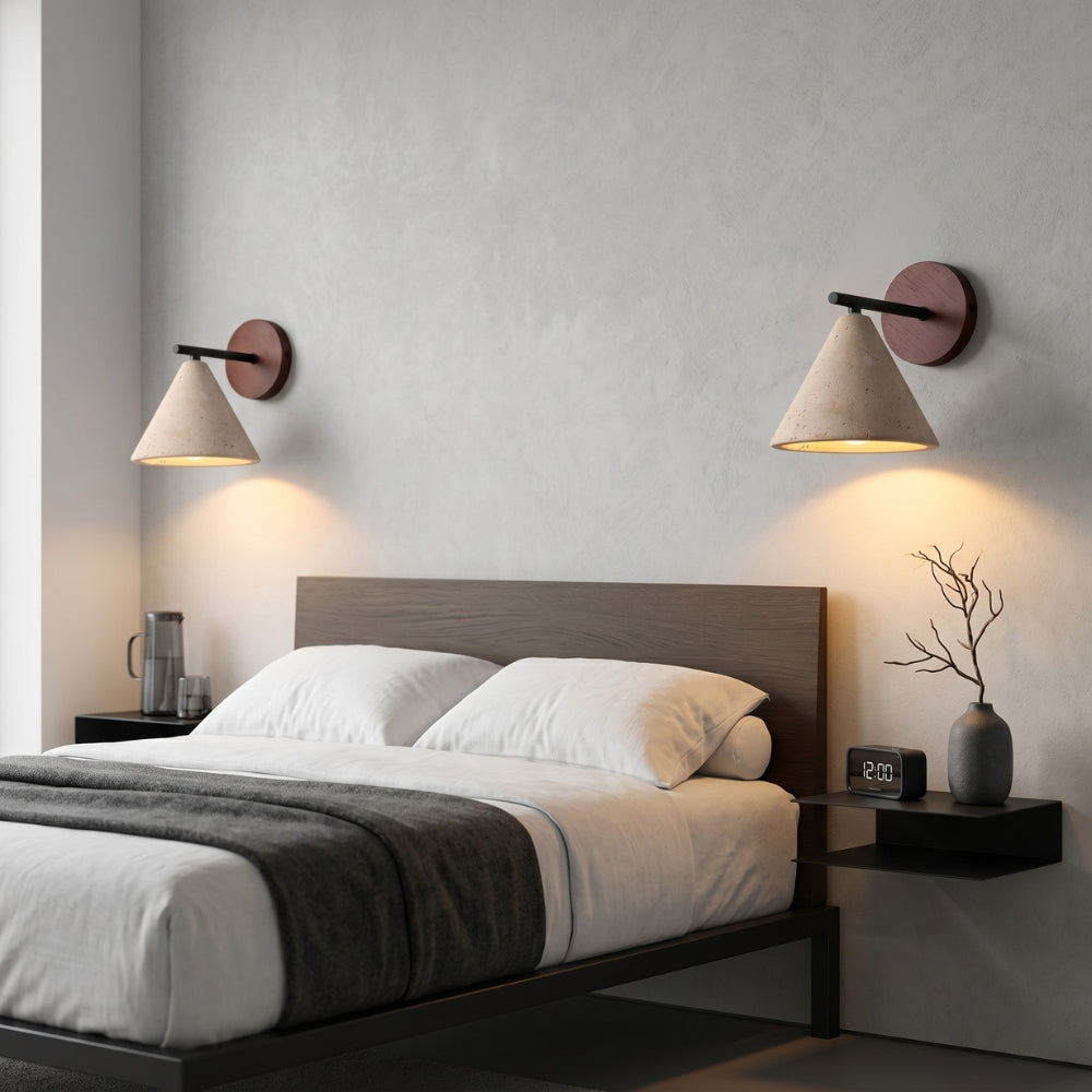 Modern bedroom with a bed, nightstands, and wall sconces.