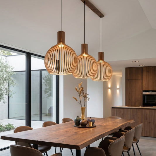 Modern dining area with wooden table and pendant lights in a well-lit room.
