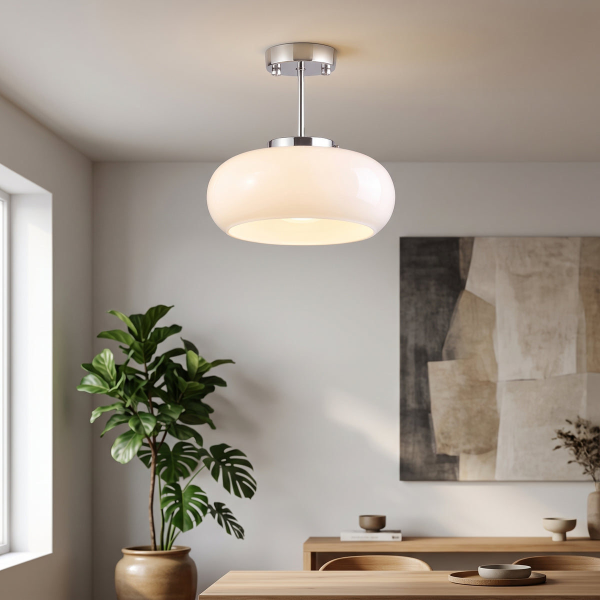 A modern semi-flush mount ceiling light with a frosted white dome shade and a polished silver metal stem, shown illuminated in a minimalist dining room setting.