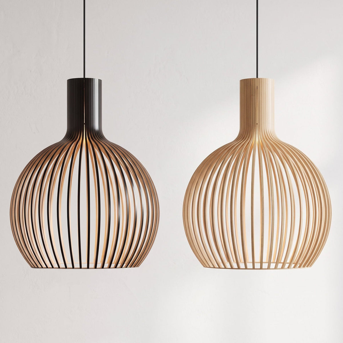 Two modern pendant light fixtures with curved slatted wooden shades hang against a plain light gray wall. One fixture has a black top collar and cord, and the other has a natural wood top collar.