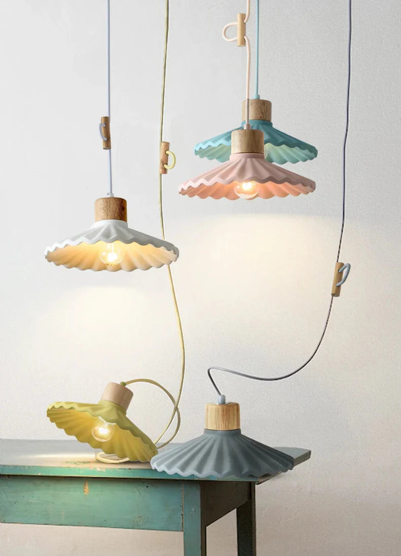 Colorful pendant lights on a table against a light background