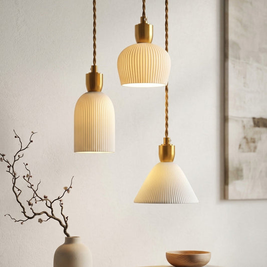 Three pendant lights hanging above a wooden surface with decor items.